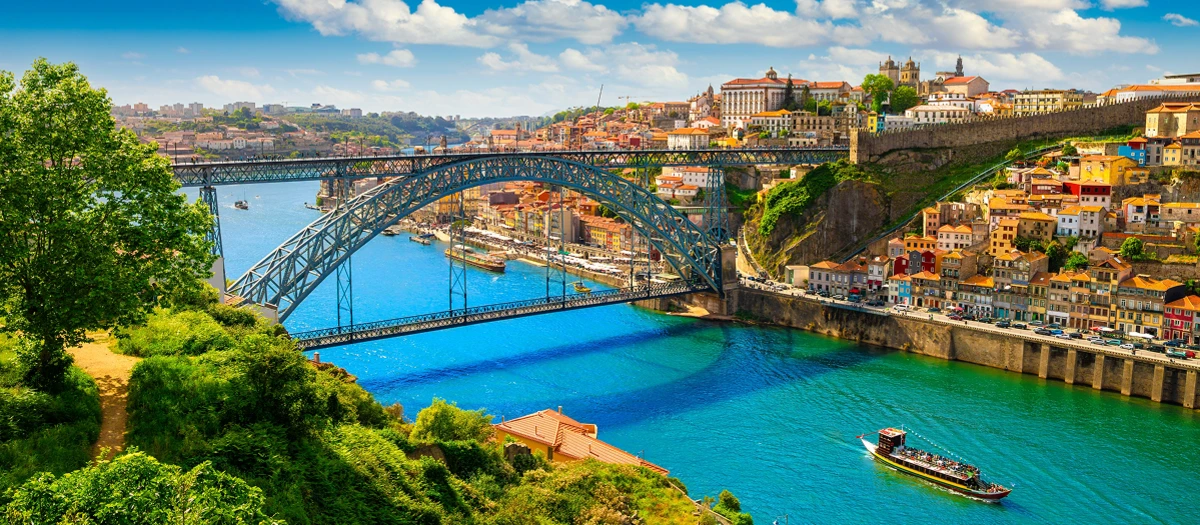 Iron bridge arching over the Douro river in Porto on a guided tour from Lisbon to Porto.