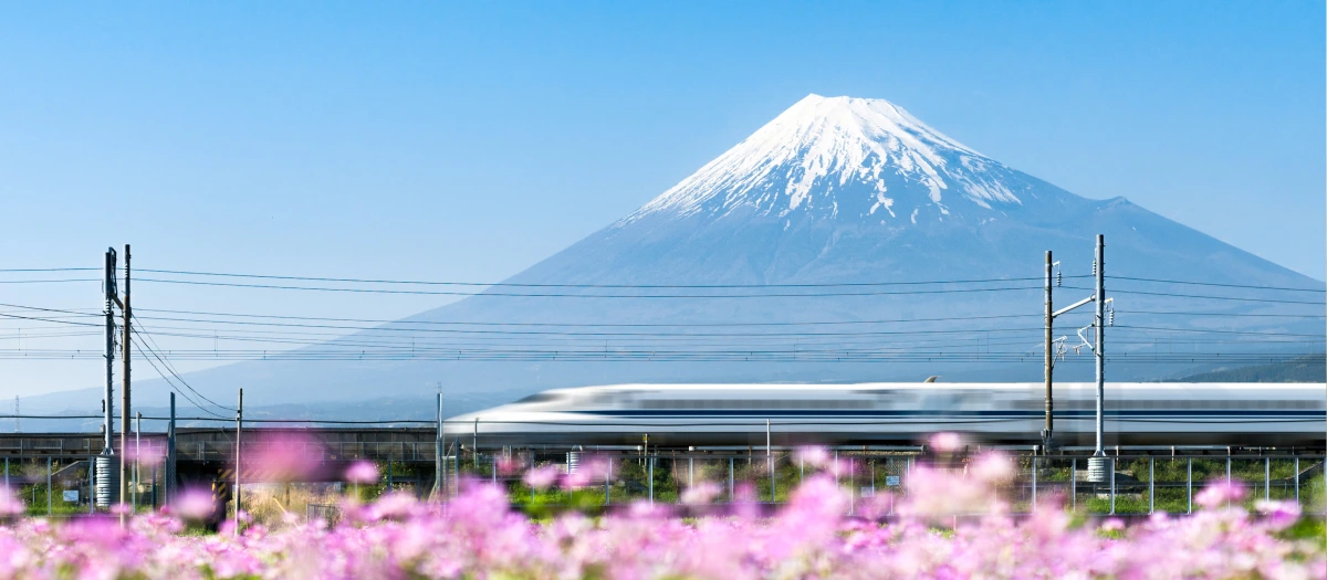 a high speed bullet train in Japan in front of Mount Fuji