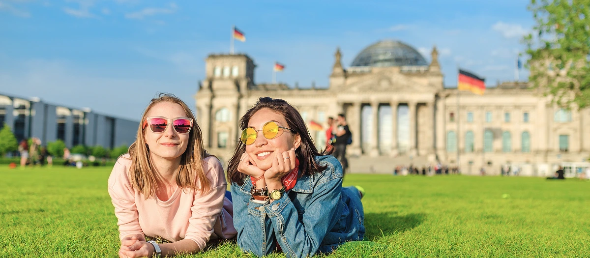Students relaxing on the lawn in front of the Reichstag in Berlin on an Experience Germany tour.