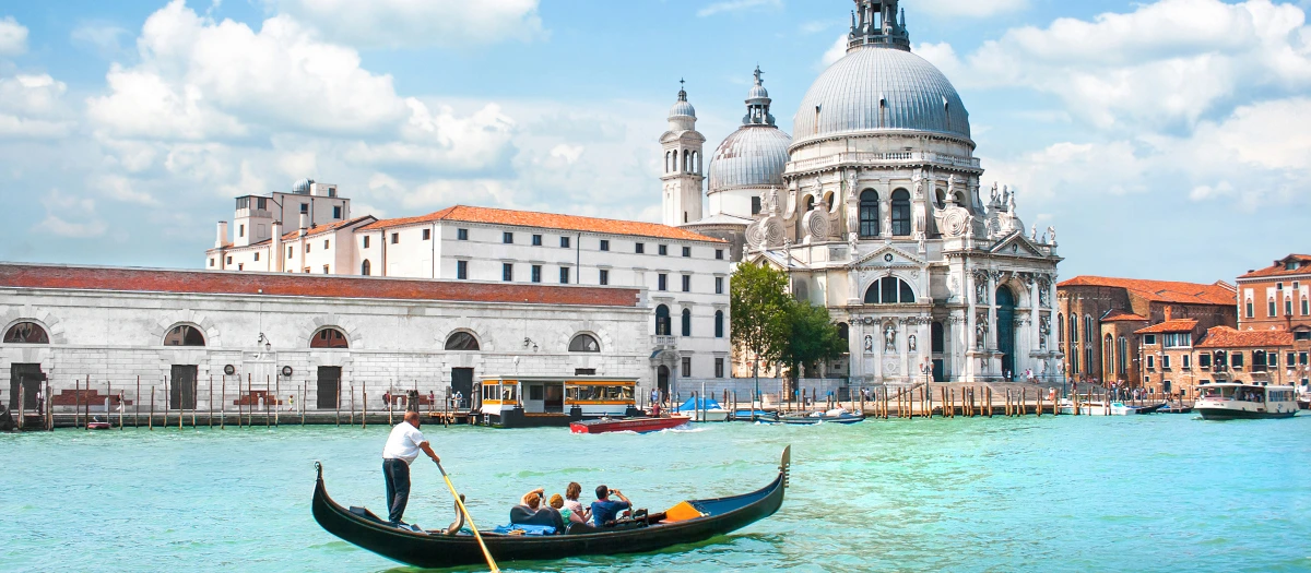 Gondola passing the domed Santa Maria della Salute in Venice on the Grand Tour of Italy.