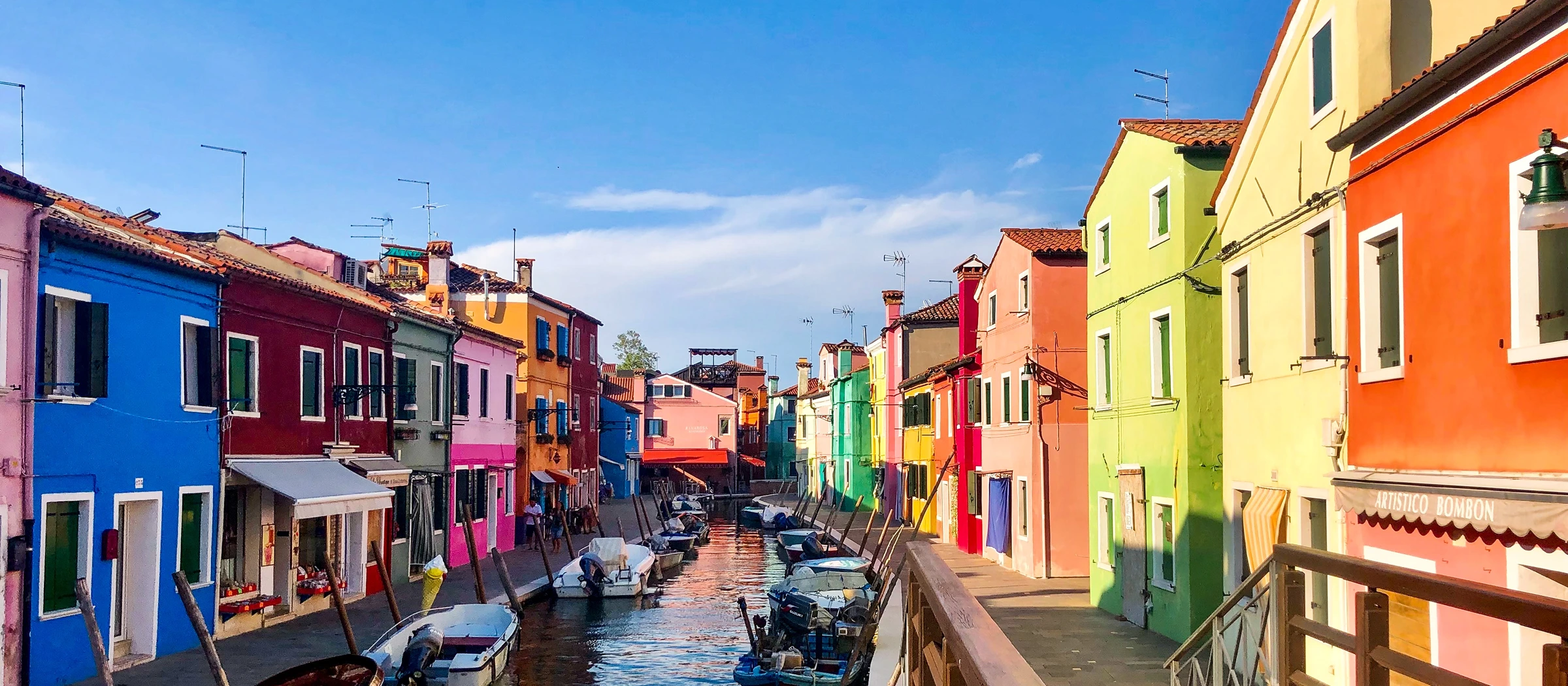 Colorful houses along a canal in Burano, Italy.