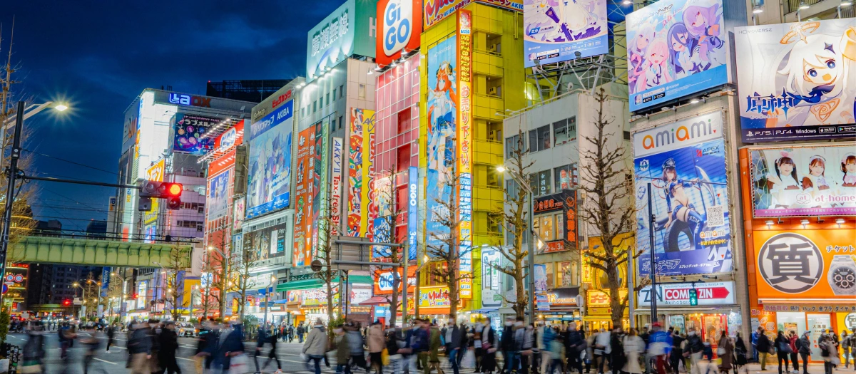 Crowded Shibuya Crossing, Tokyo Japan at night with colorful billboards 