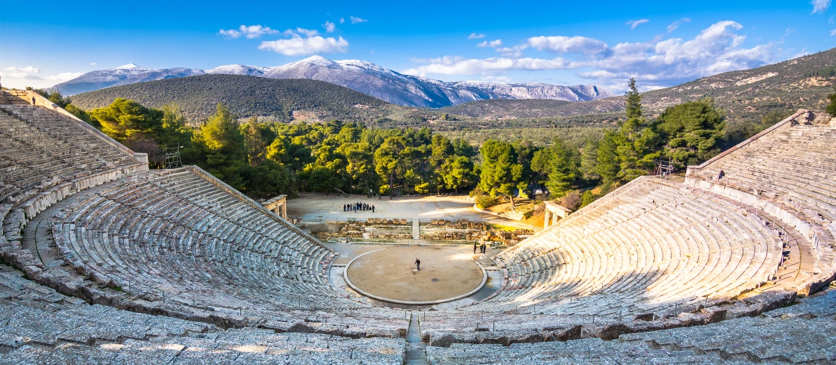 Ancient Greek amphitheatre set in a green valley, a highlight of the Grecian Odyssey tour.