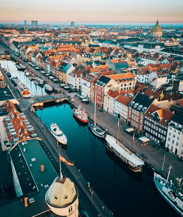 River in Denmark with boats docked.