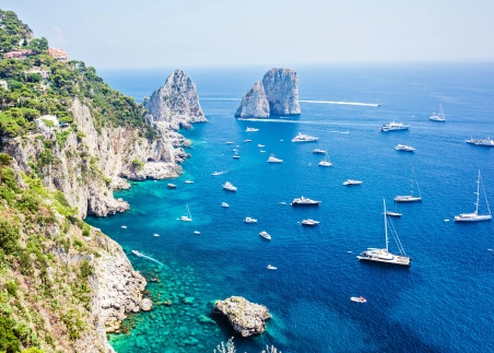 Take a boat cruise around the island of Capri, marveling at the iconic Faraglioni Rocks and vivid blue waters