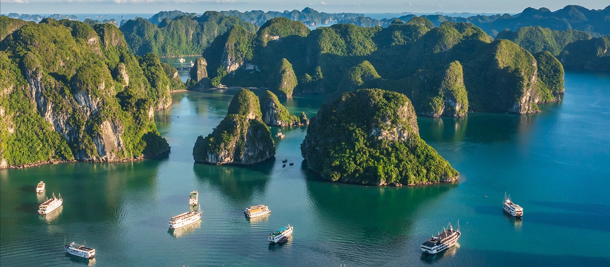 Limestone karsts rising from the water in Ha Long Bay on a Discover Vietnam student tour.