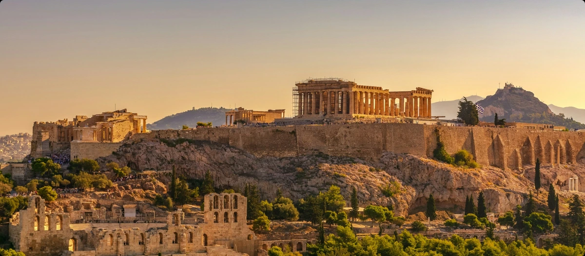Acropolis of Athens glowing at sunset above the city, a highlight of the Adriatic Odyssey tour.