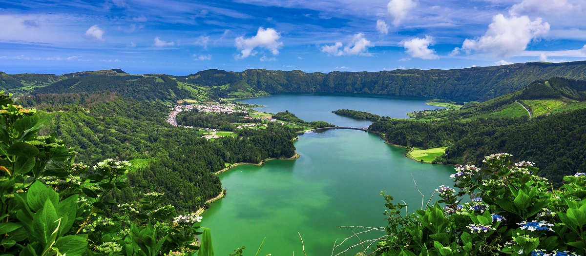 Green and blue crater lakes among volcanic hills on Azores islands student tours.
