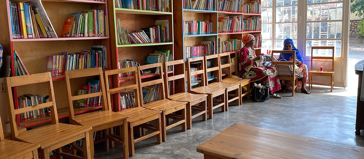 Library shelves of books and seating in Rwanda on a wildlife, culture and service tour.