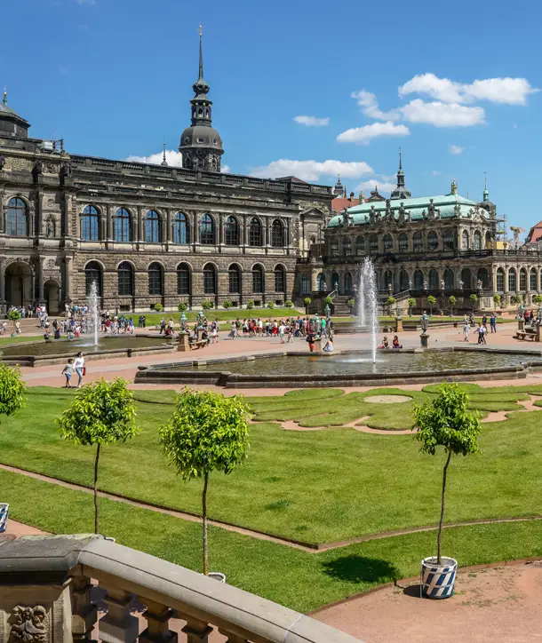 Square in Germany with green grass and fountain.