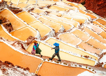 Hike across the Vilcanota River to the Maras Salt Ponds, thousands of terraced pools that harvest salt from a subterranean stream high in the Andes