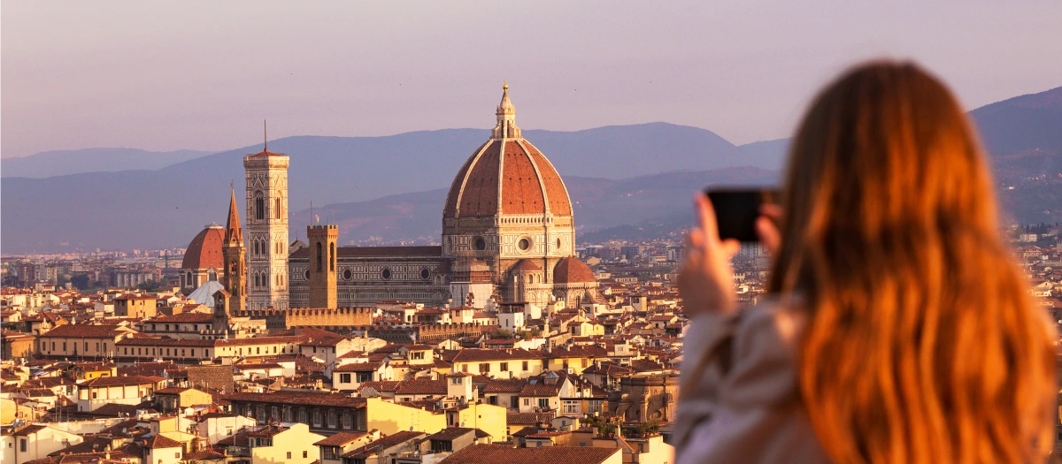 Student photographing the Florence Duomo at sunset on Rome and Florence student tours.