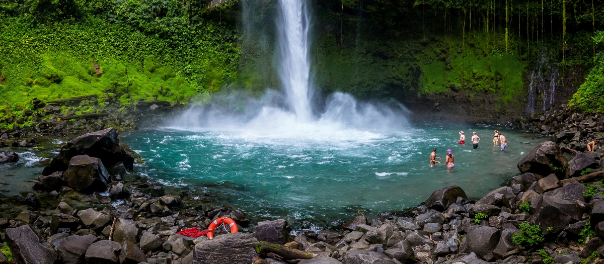 Travelers visiting a waterfall in Costa Rica.