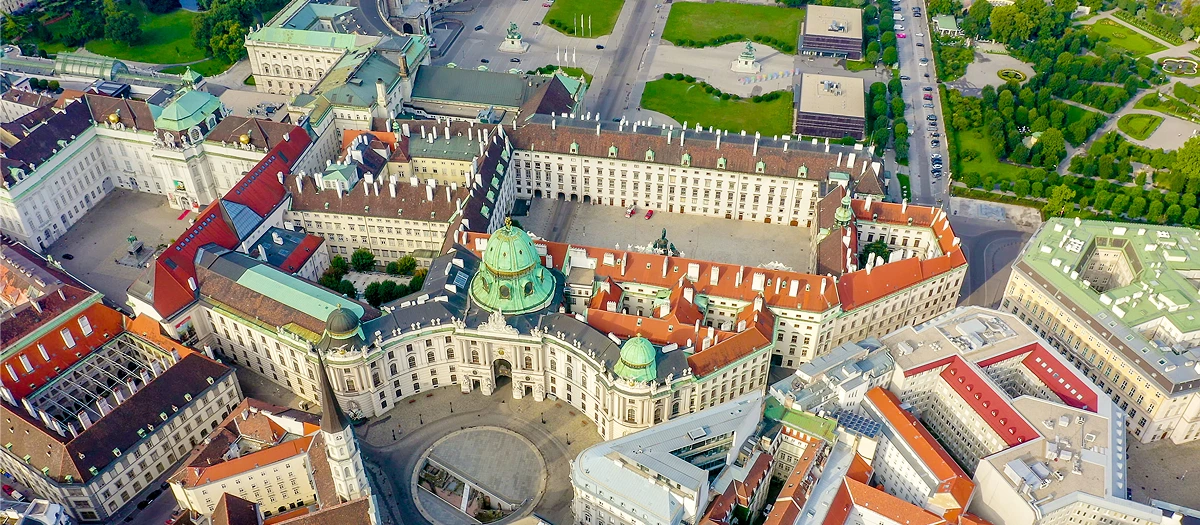 Baroque palace complex with green domes seen from above on the European Mosaic tour.