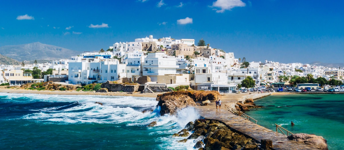 Whitewashed hilltop village above turquoise water on tours of Athens and the Greek islands.