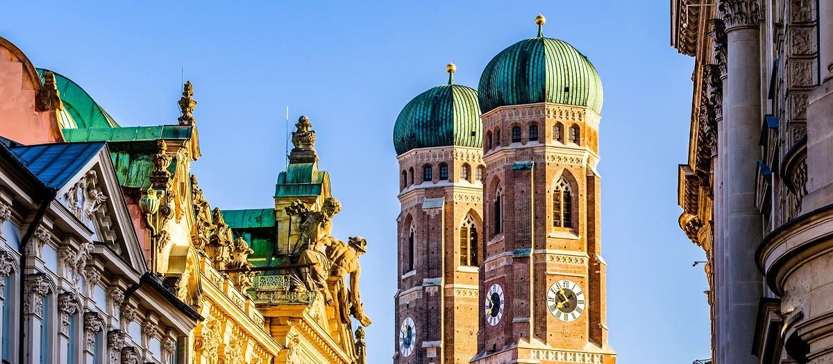 Twin onion domes of the Frauenkirche above ornate rooftops on educational tours of Germany.