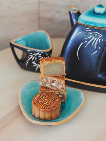 a plate of mooncakes and a teapot