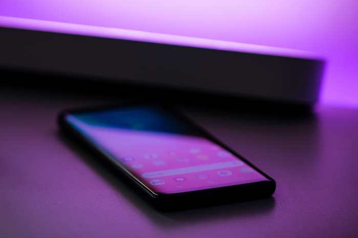 Cell Phone in purple light by Jonah pettrich