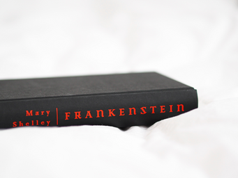 black Frankenstein book in a white sheet