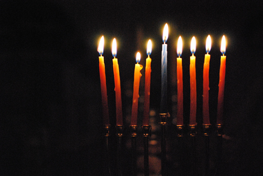 9 candles lit on menorah for hanukkah