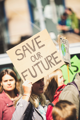 Woman holding \"Save Our Future\" sign