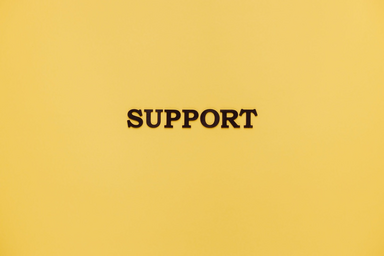 Support sign with yellow background