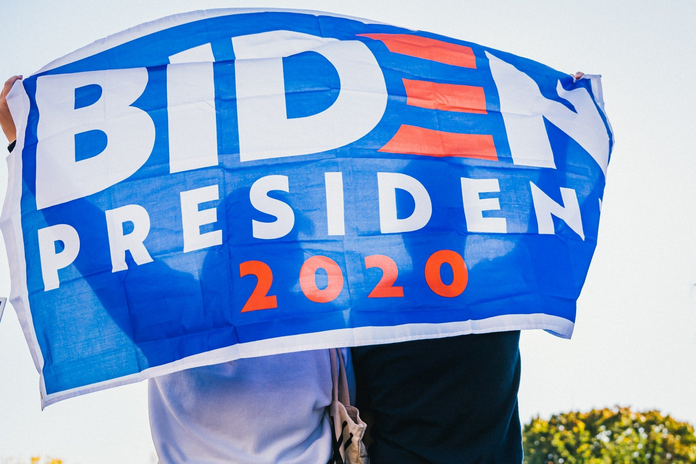 Person holding Biden 2020 flag