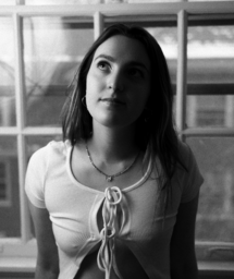 black and white photo of student jewelry line founder in her necklace