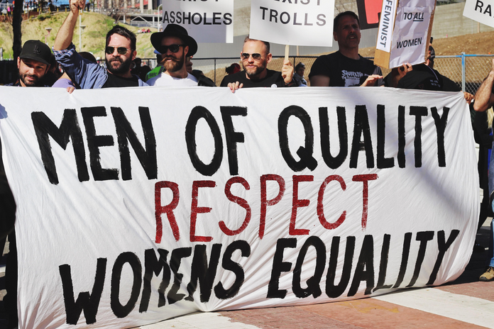 men holding gender equality sign