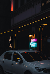 white car parked beside neon sign at night time