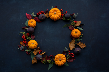 wreath with pumpkins against black background