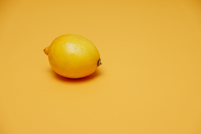 A lemon in the picture with a yellow background color