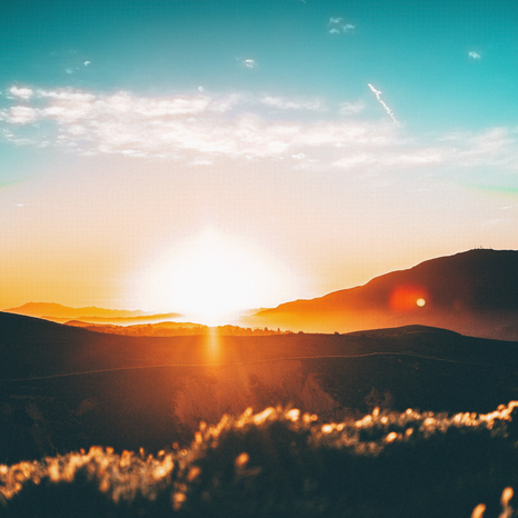 sunset over the mountains by unsplash