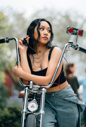 Woman leaning on motorcycle