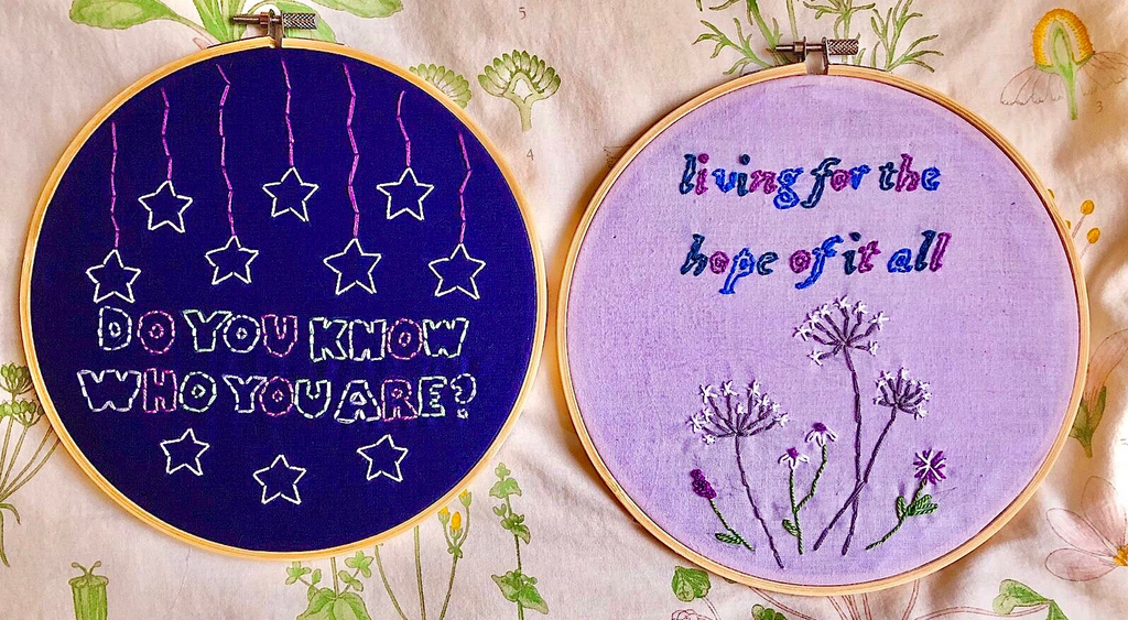 Photo of two embroidery wheels, one with lyrics from Taylor Swift and one with lyrics from Harry Styles.