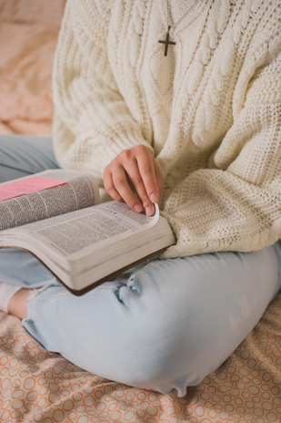 Woman in White Knit Sweater Reading Book