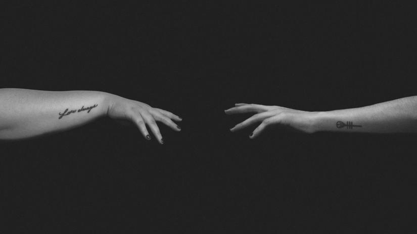 grayscale photos of people stretching hands