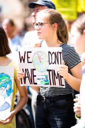 woman at climate change protest holding sign