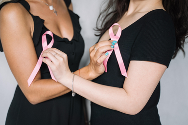 women holding breast cancer ribbons