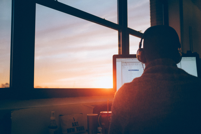 on computer with sunset in background by Simon Abrams via Unsplash