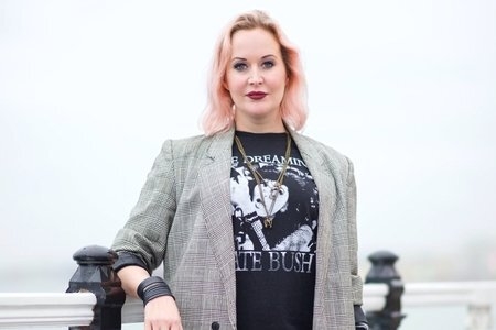 woman in blazer and graphic t-shirt