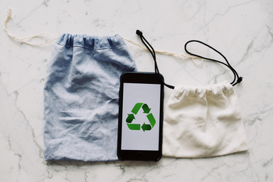 phone with recycling symbols and bags