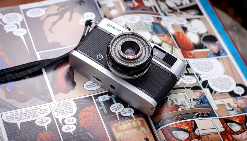 Vintage camera on top of spider-man comics