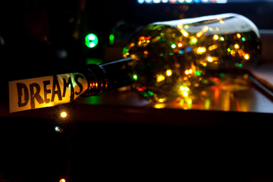 Bottle of lights with the word \"dreams\"