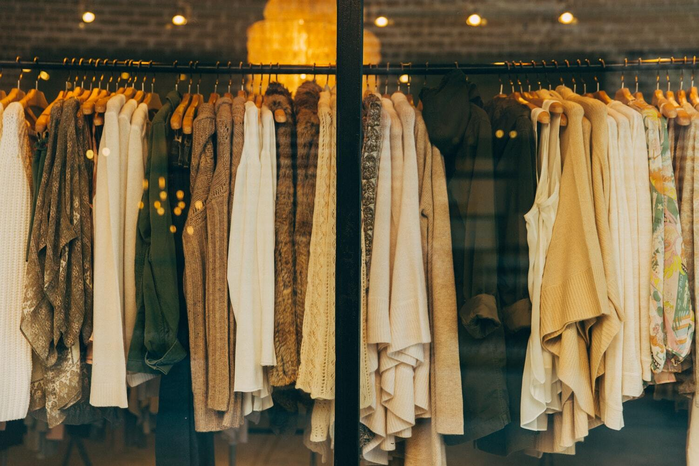Clothing rack of brown tops by Hannah Morgan Unsplash