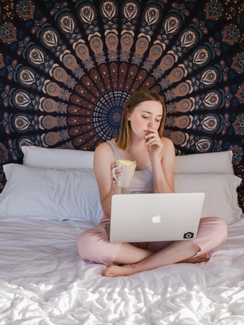 woman sitting on bed by Sincerely Media on Unsplash