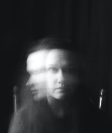 blurry black and white photo of woman by Callie Gibson