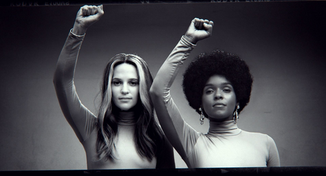 Alicia Vikander (as Gloria Steinem) and Janelle Monáe (as Dorothy Pitman Hughes) in THE GLORIAS