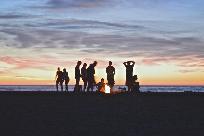 friends by fire on beach