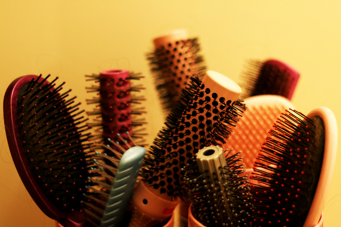 hair brushes in a container by Kevin Doncaster